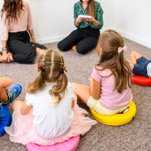Children sitting in a circle in group therapy